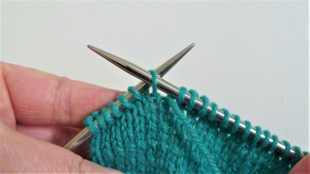 Wrap and turn short rows. Slip next stitch from left needle to the right.