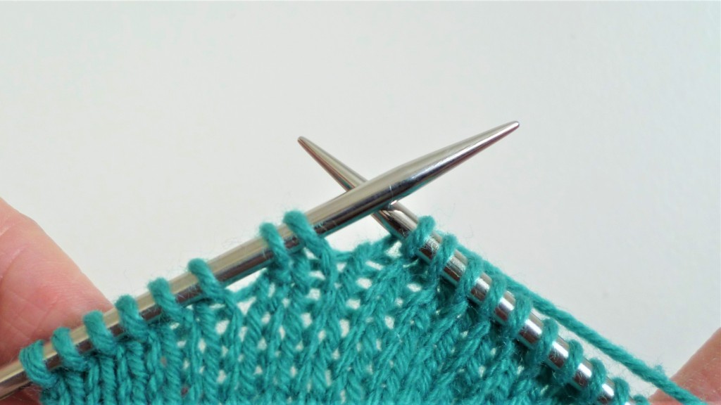 Wrap and turn short rows. Work to one stitch before last wrapped stitch. A small gap is visible between the last wrapped stitch and those stitches before the short row section.